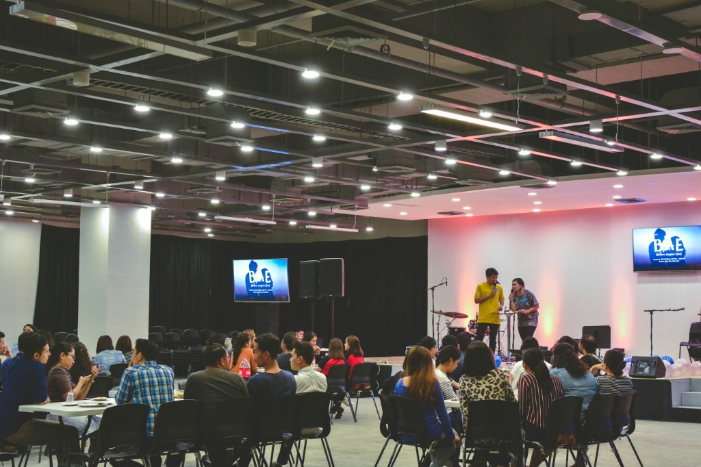 Speakers addressing a seated audience in a conference hall